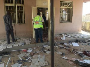 A National Emergency Management Agency (NEMA) staff inspects the damage at the site of a suicide bomber attack in Mubi in Adamawa state