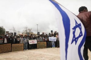 African migrants hold placards during a protest outside Israel’s Supreme Court in Jerusalem