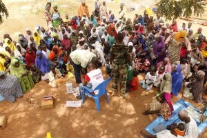 People who were rescued after being held captive by Boko Haram, sit as they wait for medical treatment at a camp near Mubi