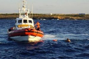 Desperate migrants jump off rescue ship into sea seeking to swim to Italy