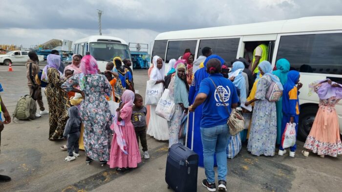 Returnees-boarding-bus-at-the-airport-2048×1153